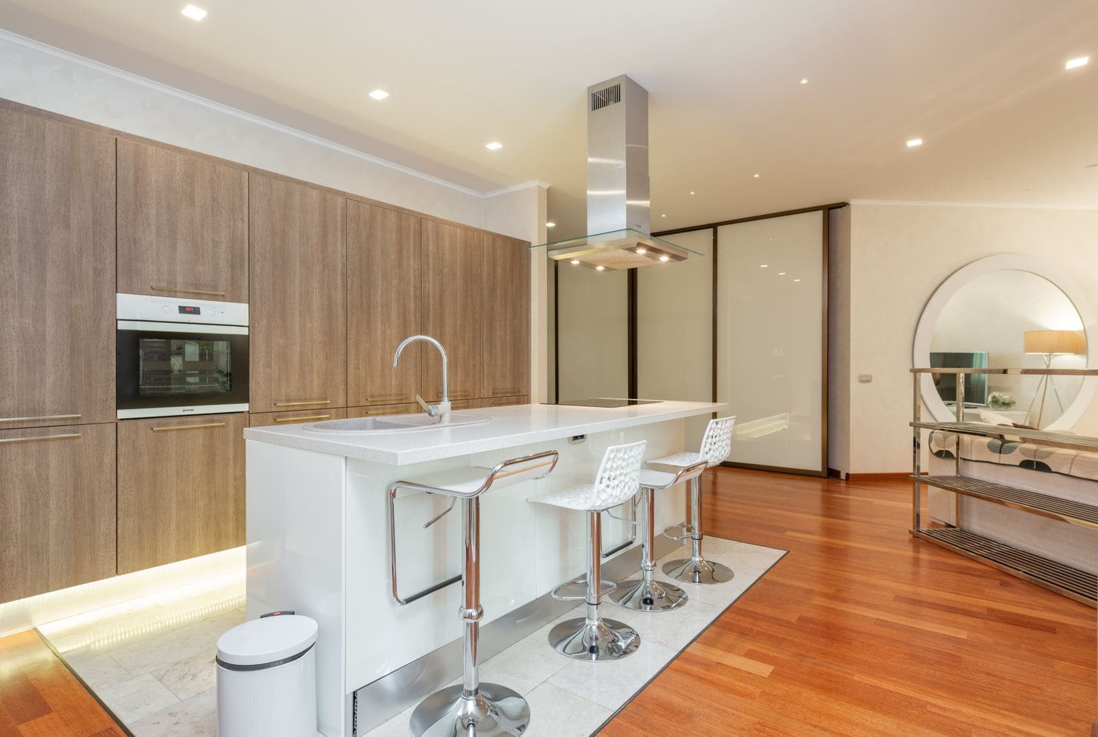 Minimalist kitchen zone with modern appliances in a spacious studio apartment