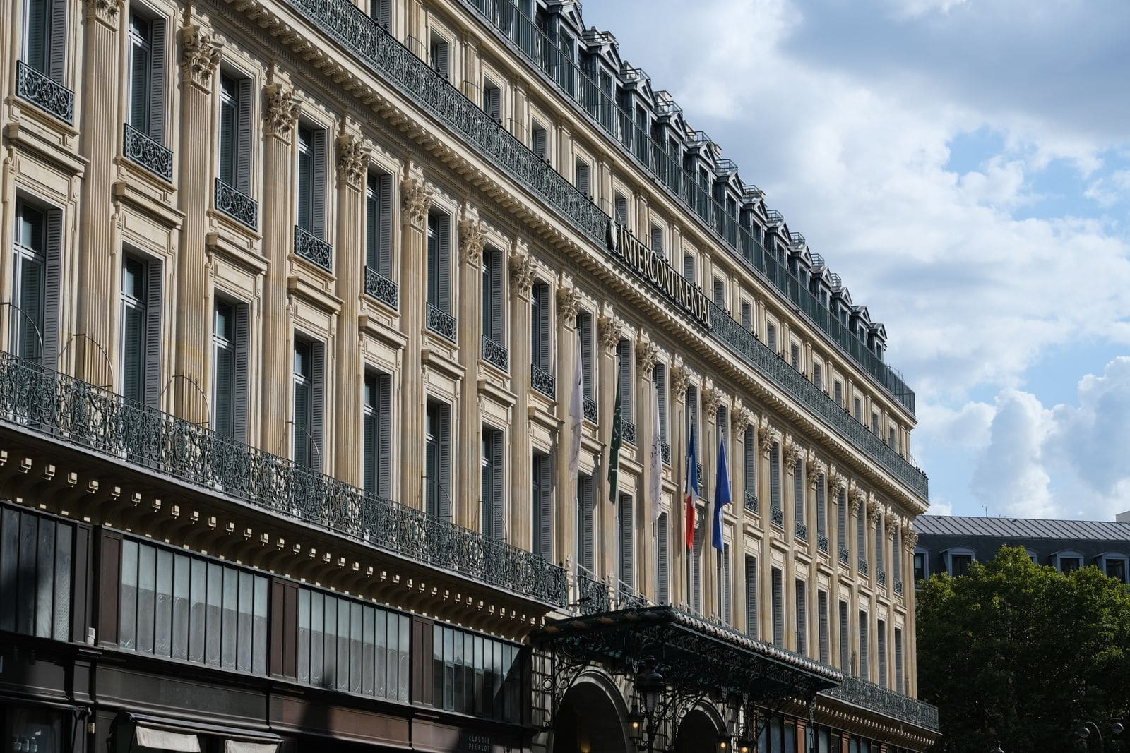 Elegant facade of a luxury hotel with ornate iron railings