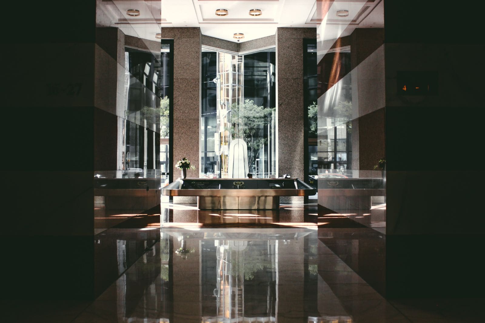 Modern hotel lobby with glossy floors and daylight