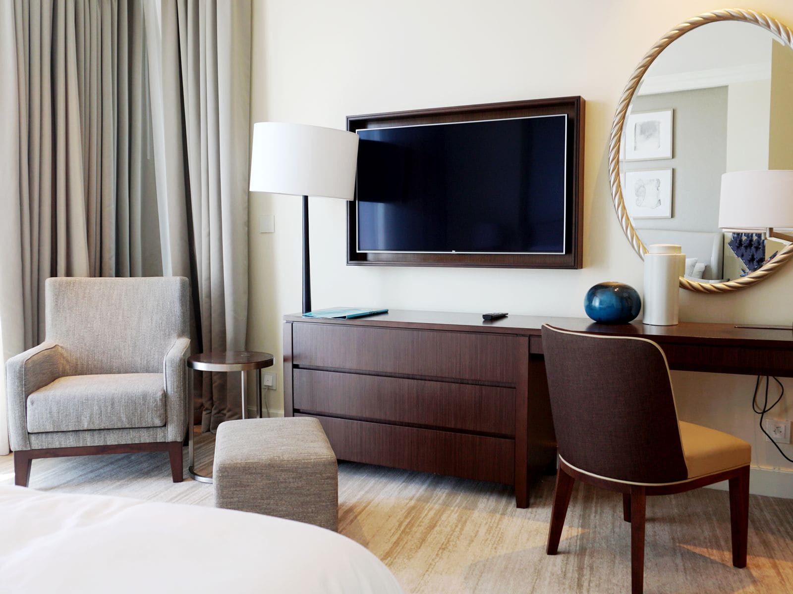 Chic hotel room with modern furniture and a wall-mounted TV