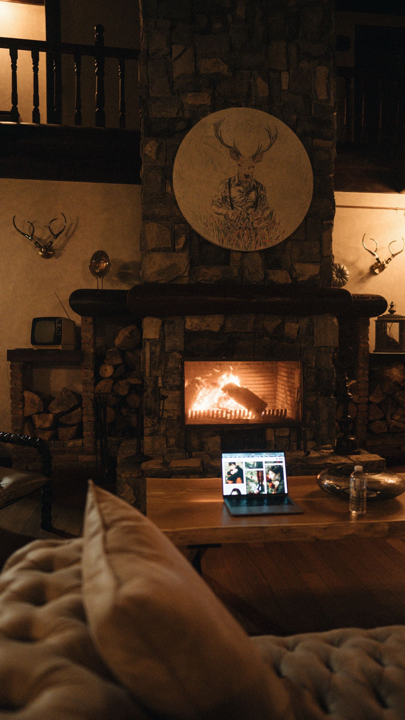 Cabin fireplace glowing in a cozy interior