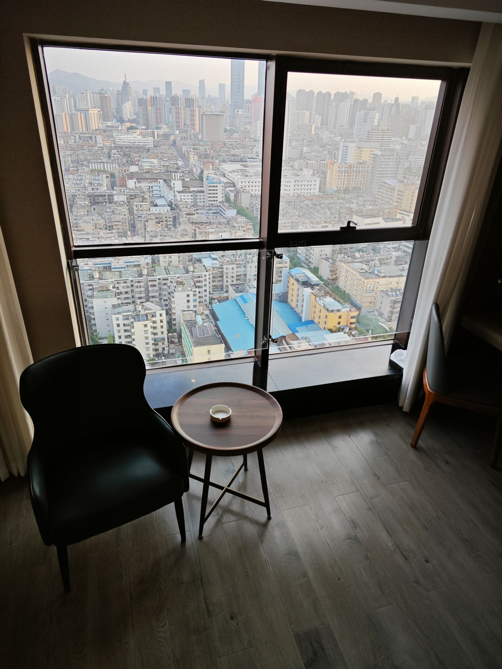 Cityscape view from a high-rise room window