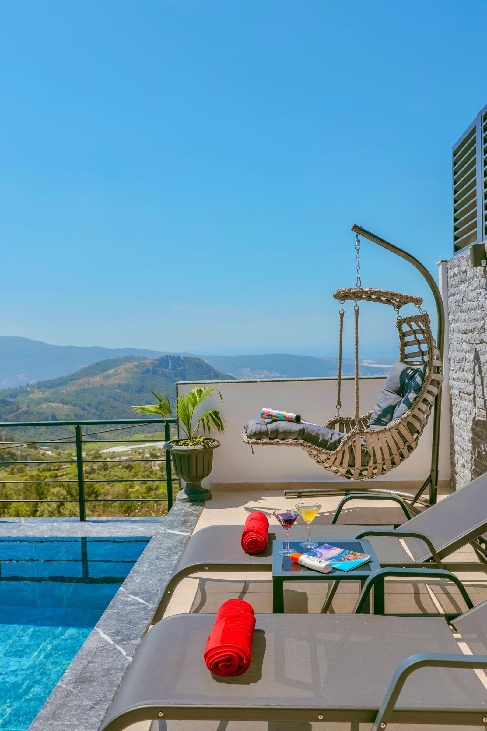 Swimming pool and sun loungers on a scenic deck
