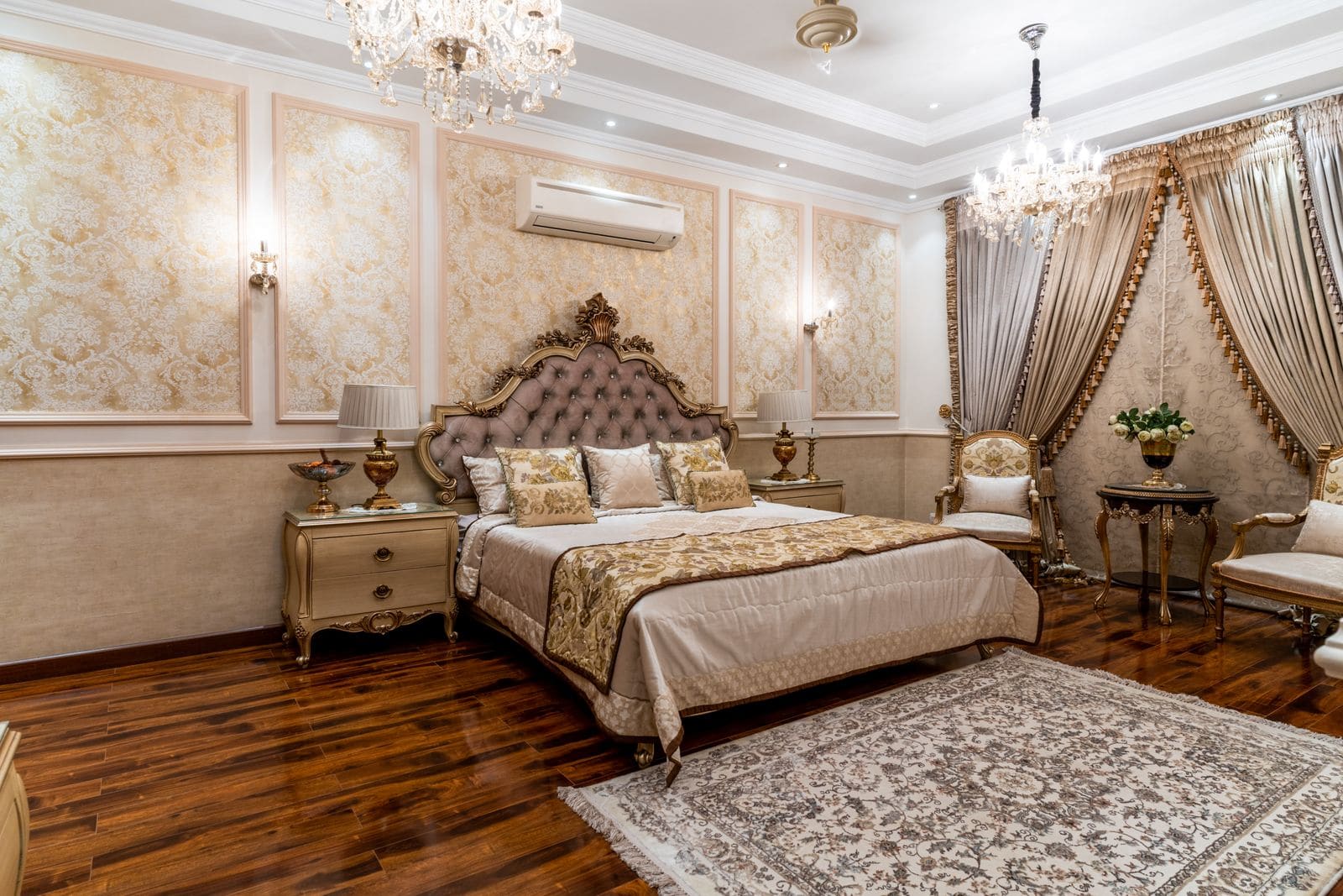 Ornate hotel room with chandeliers and gold accents