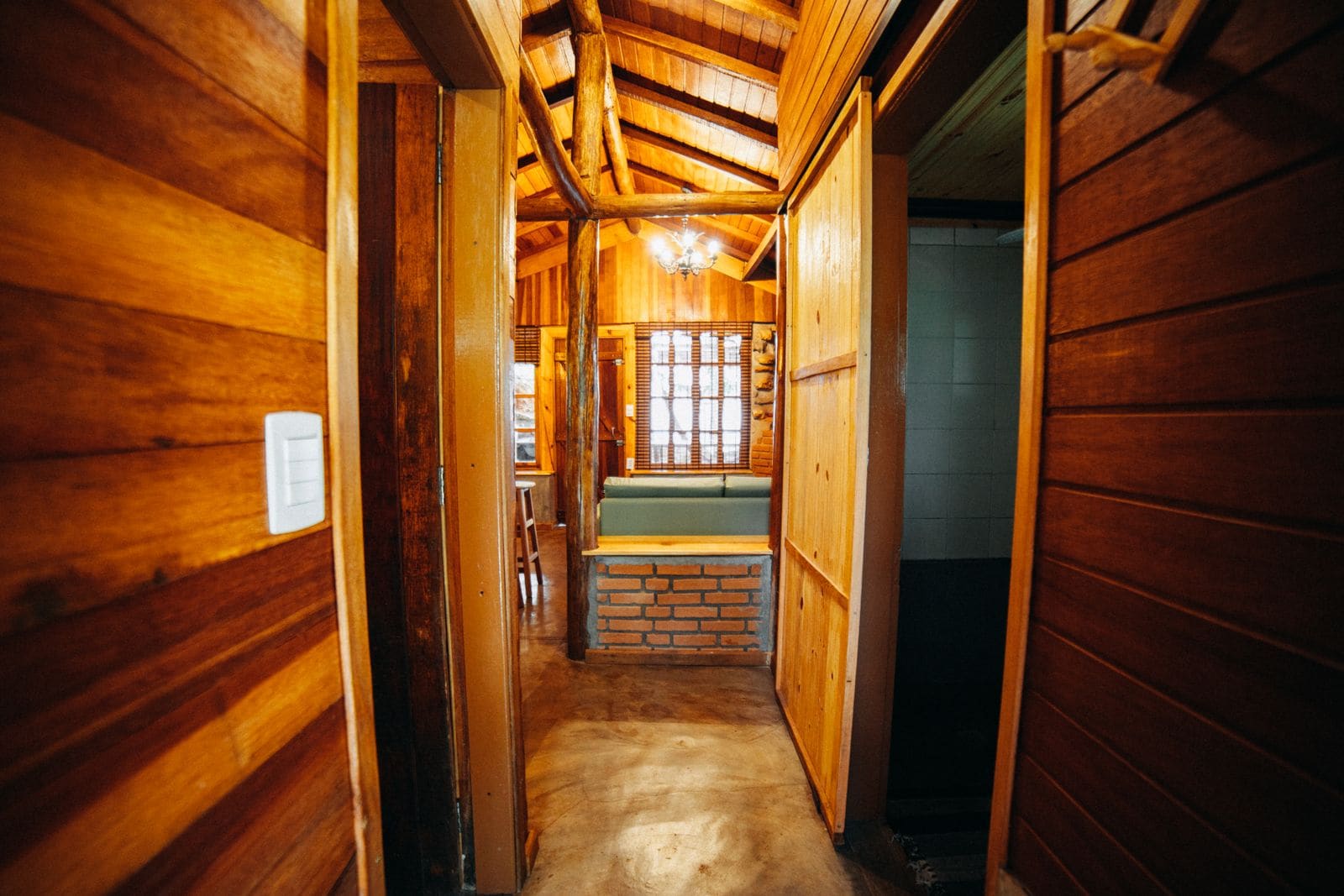 Wooden hallway with numbered doors in a timber lodge