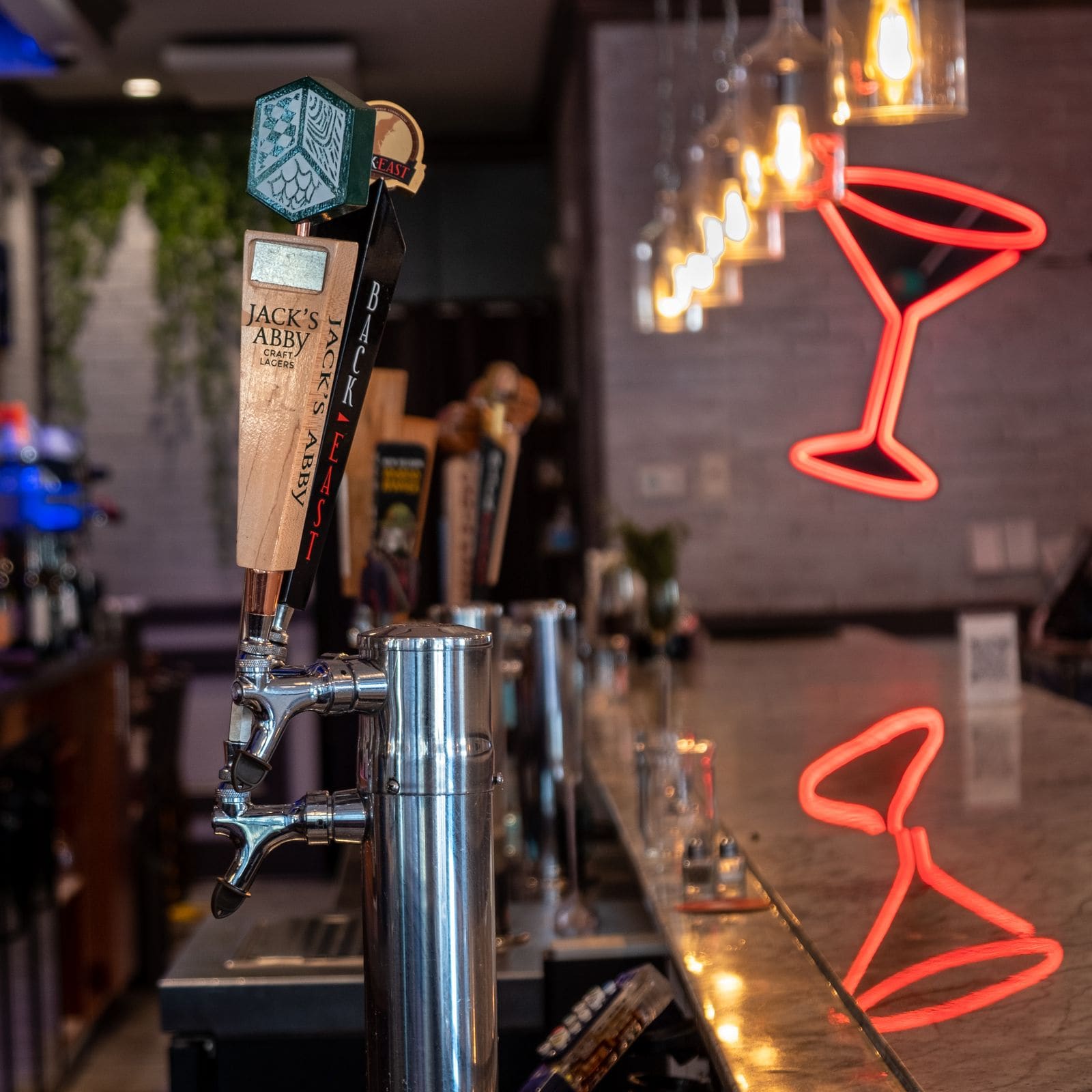 Chic bar interior with a neon cocktail sign