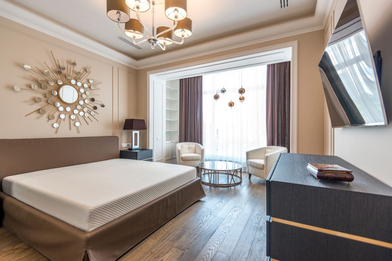 Furnished hotel room with a bed and a seating corner