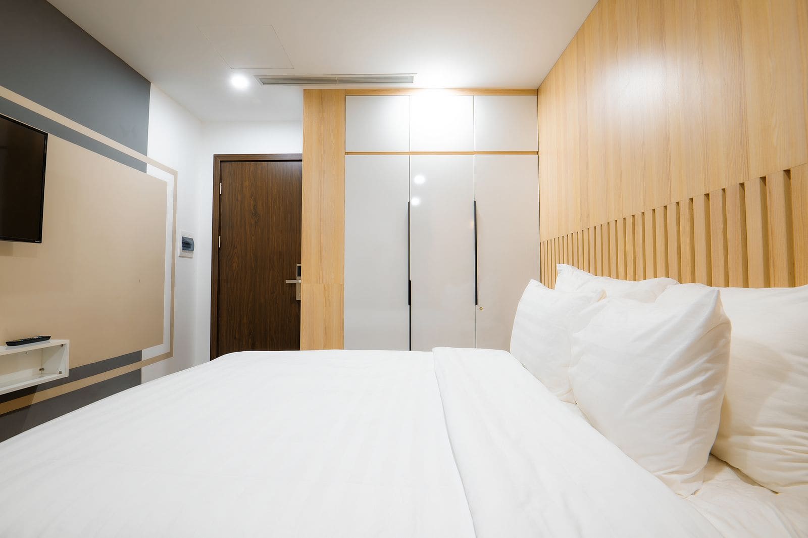 Minimalist hotel room with wooden wall panels
