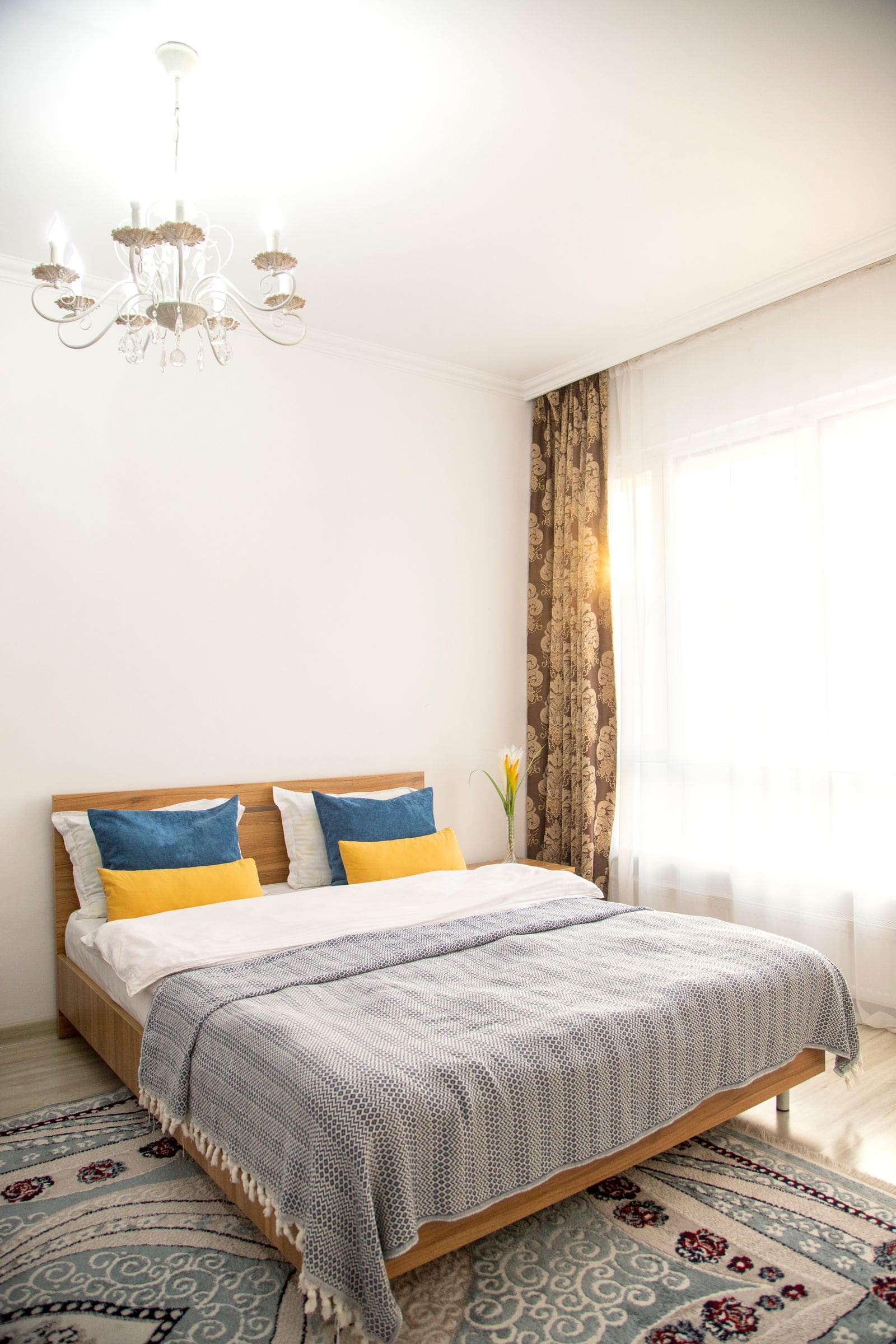 Bedroom with a chandelier hanging above the bed