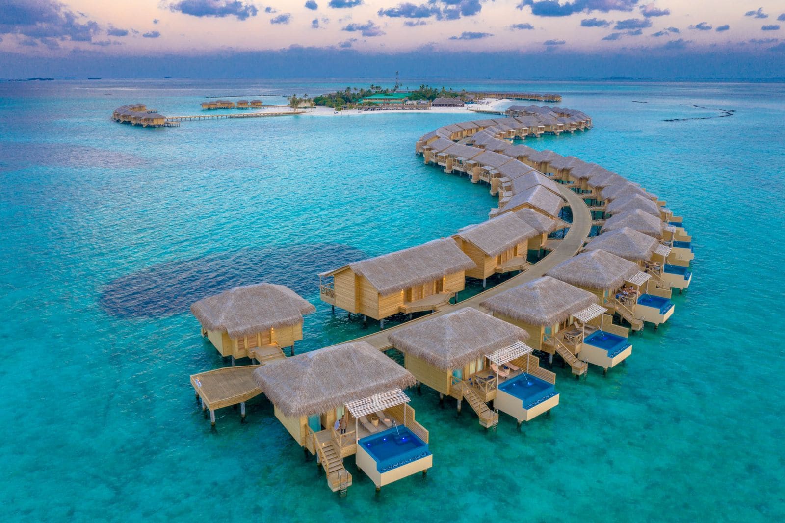 Luxury water villas in the Maldives at sunset