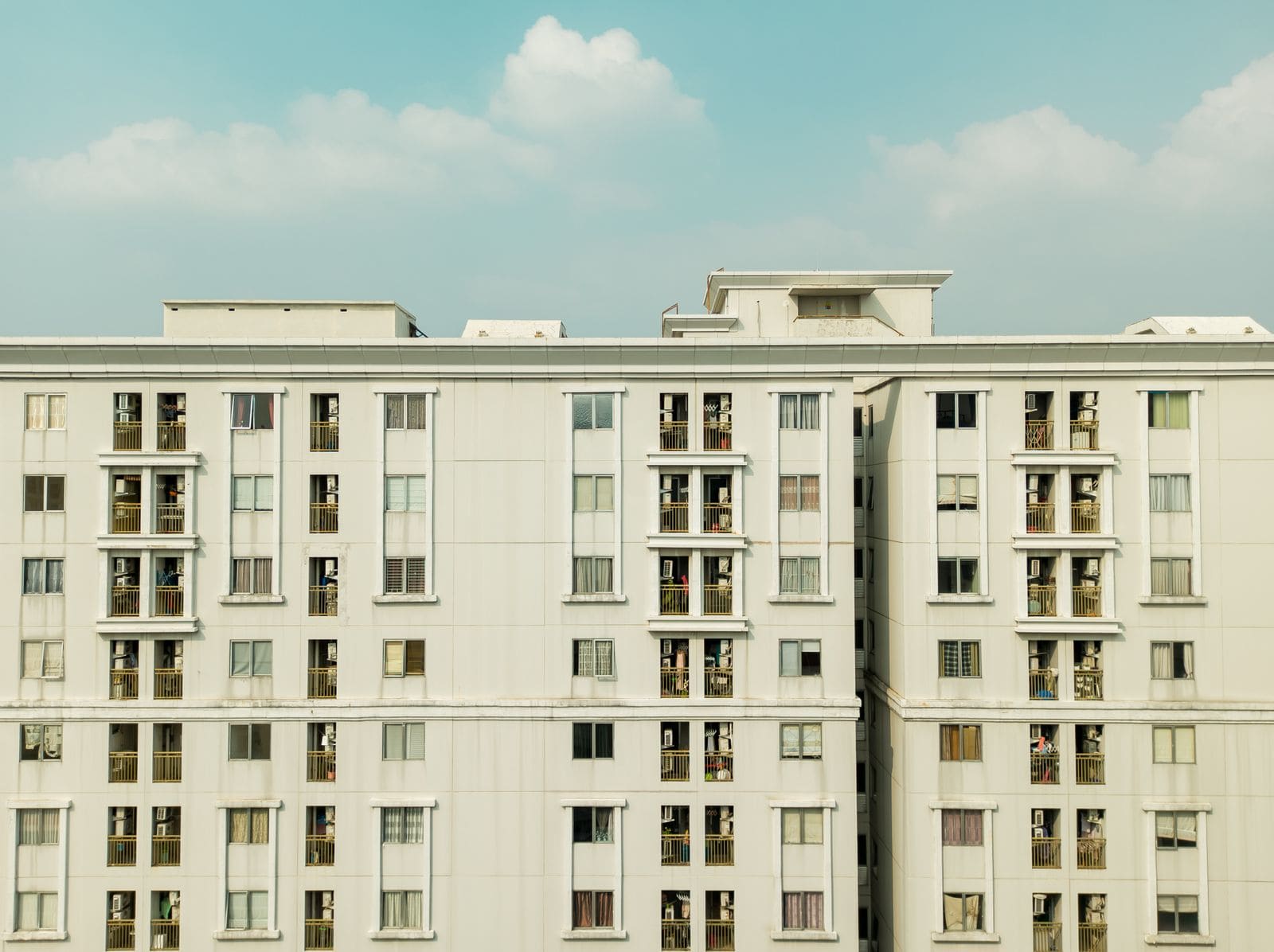 Exterior of a high-rise apartment building with balconies