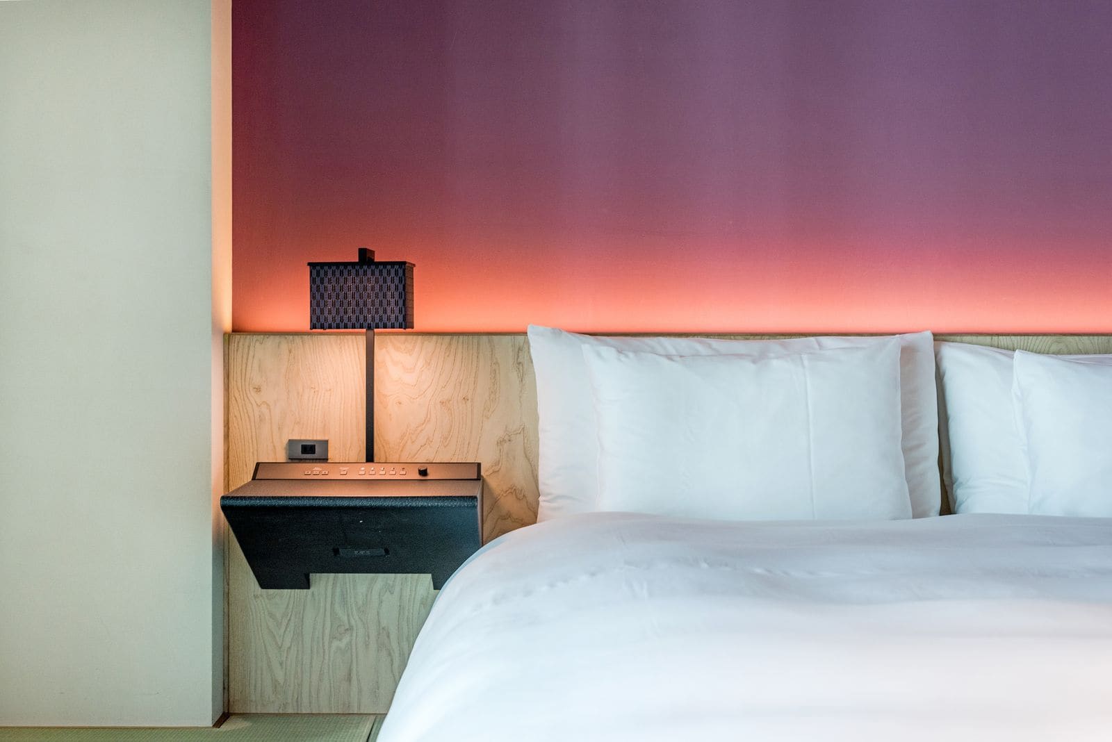 Neatly made bed with plump pillows in a hotel room