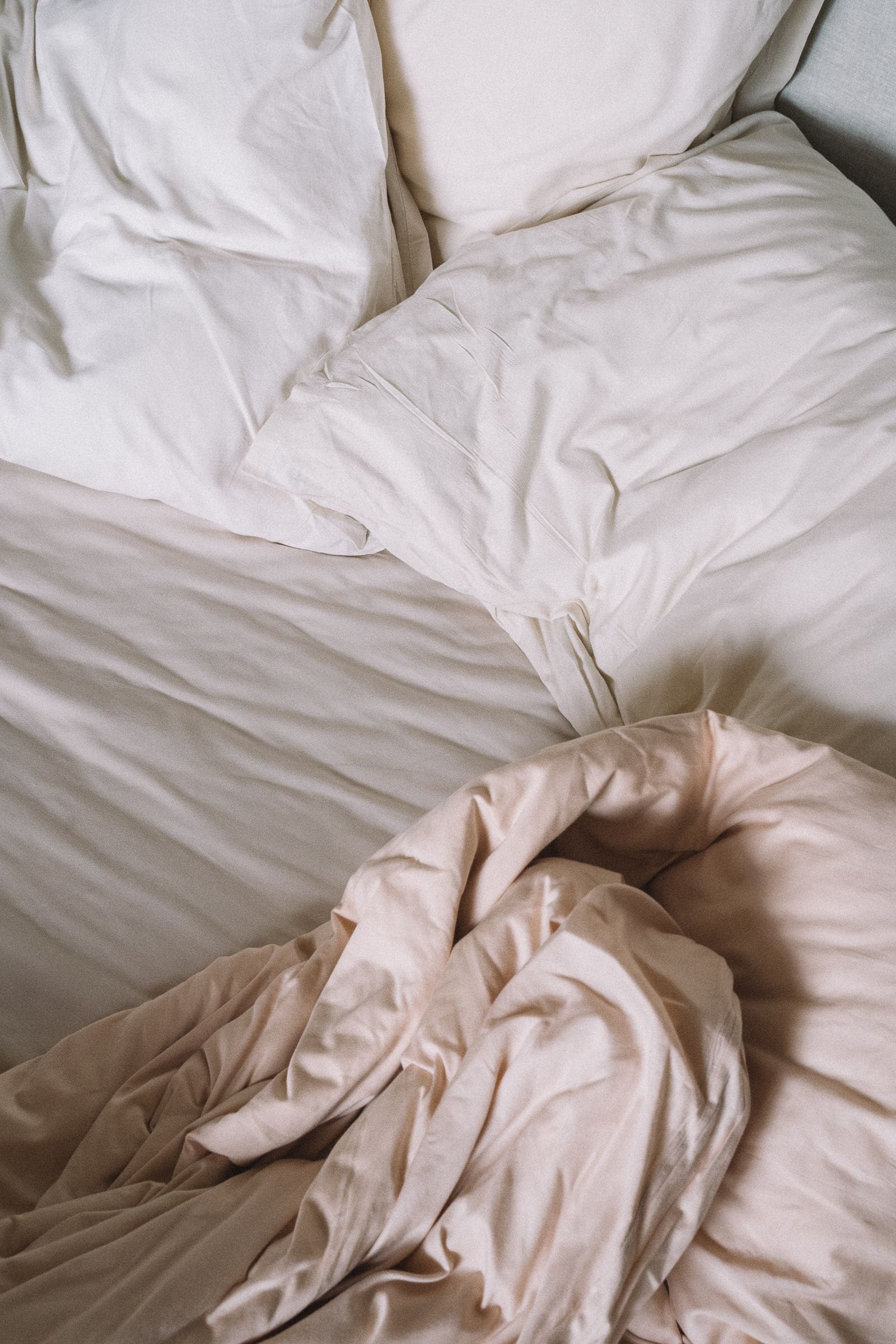 Pillows and a folded blanket on a made bed