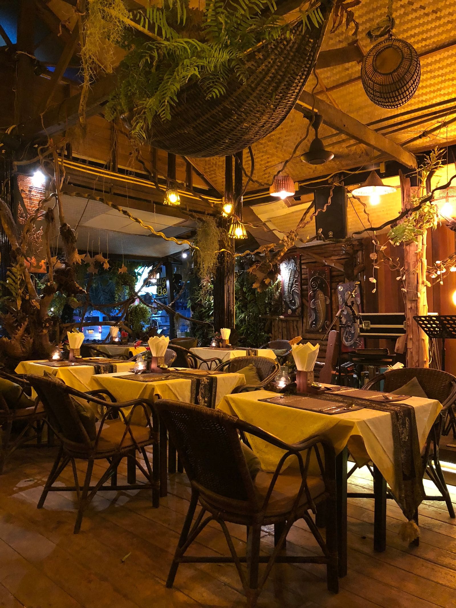 Rustic restaurant tables and chairs in warm light