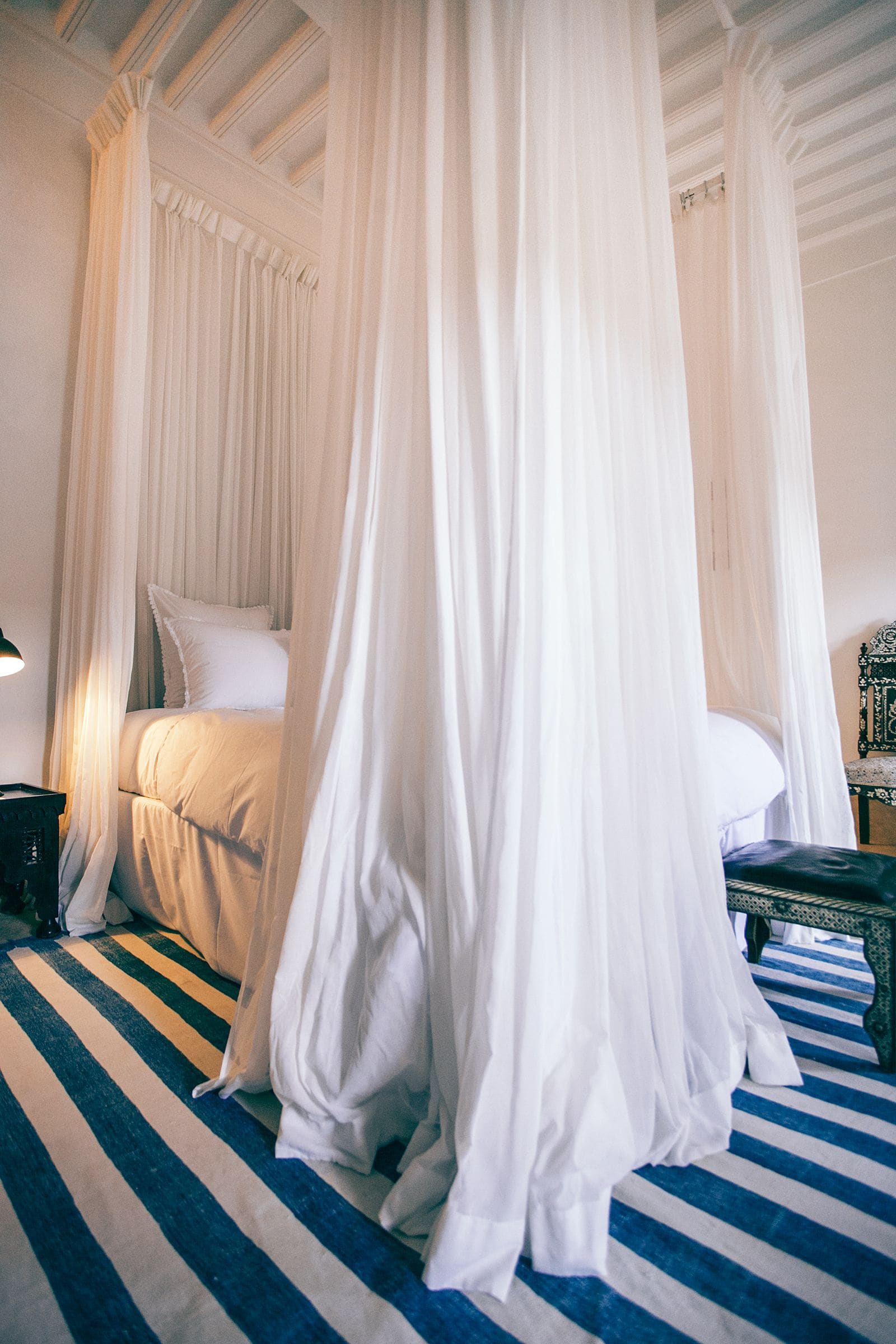 White canopy bed in a stylish hotel bedroom