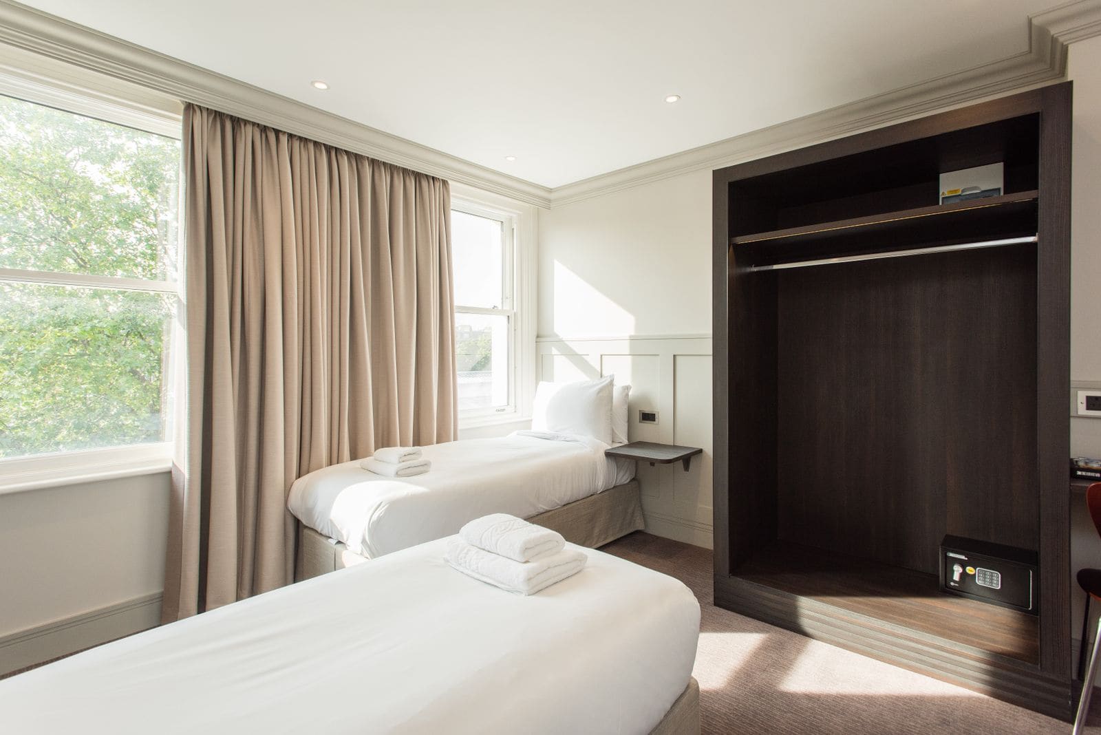 Twin beds in a simple hotel room